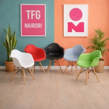 Collection of EO1571 Eames armchairs in multiple colors including white, red, black, blue, and green, staged in a Westlands Nairobi furniture studio.