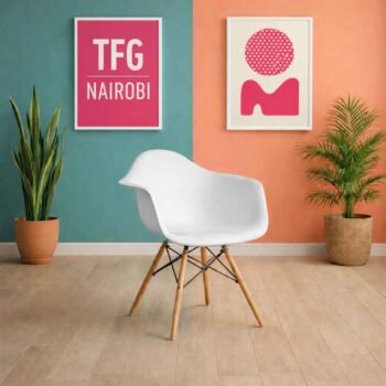 White EO1571W Eames armchair with wooden legs and molded plastic seat in a Westlands Nairobi design studio.