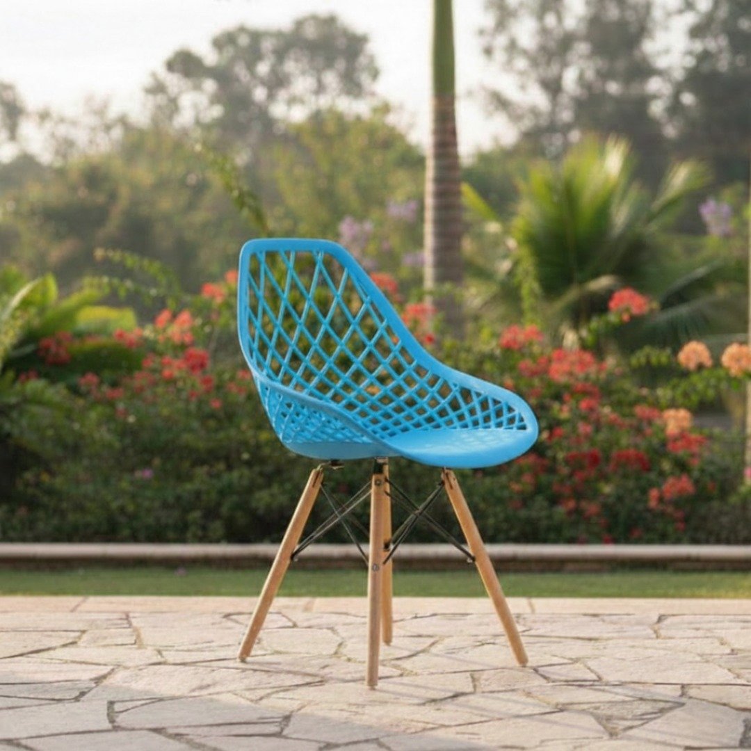 EO197BL Blue Eames Chair – Karen Collection Vibrant blue EO197BL Eames chair with beech wood legs photographed in a lush Karen estate.