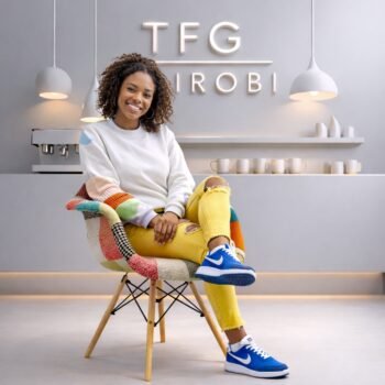 Happy client sitting on an EO8418 Patchwork Eames fabric armchair with wooden legs in a modern Langata Nairobi home interior.