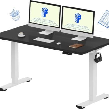 FlexiSpot EN1BW 1.4M Electric Height Adjustable Standing Desk with executive black tabletop and white frame, featuring a dual-monitor setup in a Kilimani home office.