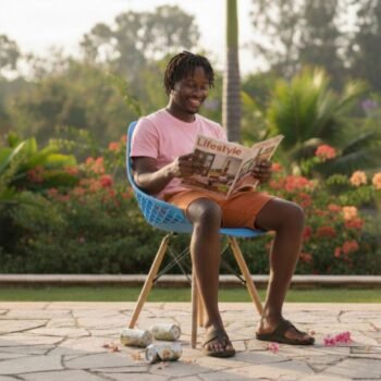 Man reading a magazine while sitting on a comfortable blue EO197BL Eames molded chair in Lavington.