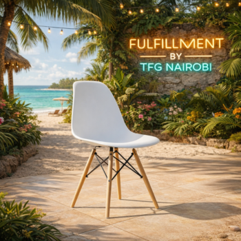 White EO196W Eames chair with wooden legs on a sunny tropical patio in Diani, Ukunda, featuring TFG Nairobi resort fulfillment branding.