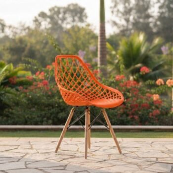 Full front view of the vibrant orange EO197O Eames chair on a modern patio in Kilimani.
