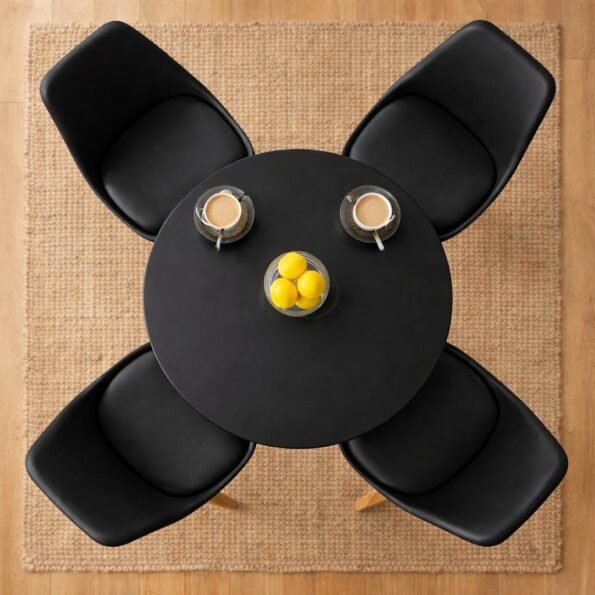 Top-down birds-eye view of a black HM7813 round dining table with four matching black chairs on a jute rug in Karen, Nairobi.