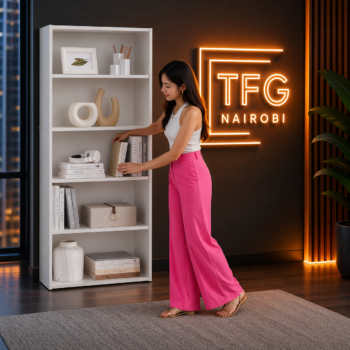 A lady in pink trousers reaching for a book on a TFG-B800 white 5-tier bookshelf in a luxury living room at Mimosa, Runda, Nairobi.
