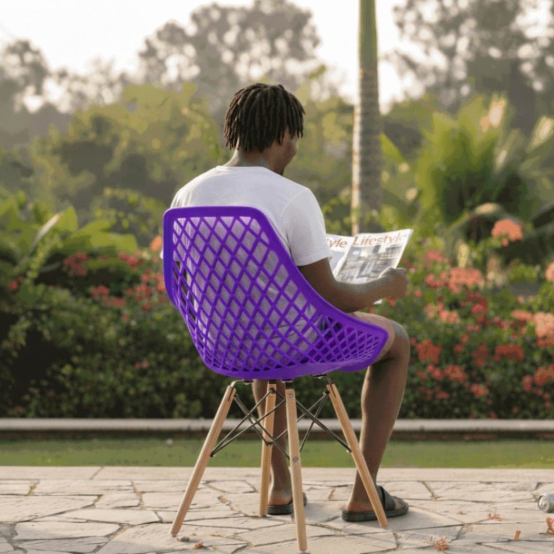Runda Estate Seating – EO197P Purple Rear perspective of a man sitting on a purple EO197P Eames chair in a Runda estate home.