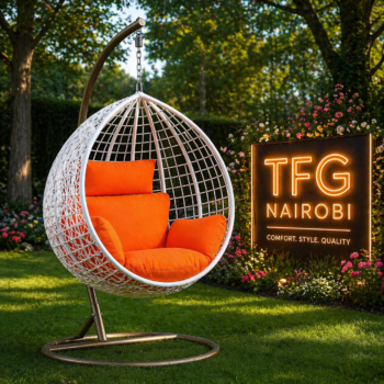 A premium SERENGETI WO188-BC swing chair with vibrant orange cushions and a heavy-duty metal stand, displayed in a lush garden setting in Karen, Nairobi.