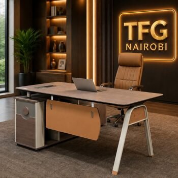 A modern SESSI YT55 1.6m executive office desk with integrated storage and cable management, paired with a tan leather chair in a luxury Gigiri office.