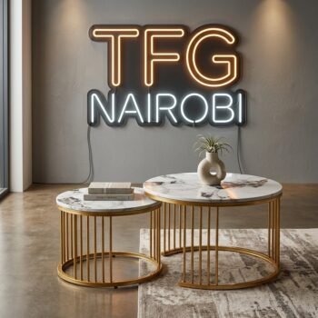 Styled J304 nesting coffee tables with white marble tops, gold frames, and decorative essentials in a modern Kileleshwa studio, Nairobi.