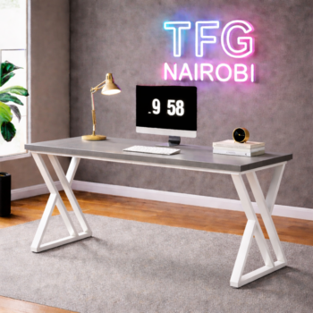 Modern STUDIO C GRWH400 computer desk with a sleek matte grey top and white architectural X-frame metal legs in a luxury Ineza, Runda home office, Nairobi.