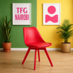 Vibrant ruby red EO1300R-1 Eames chair with matching red legs in a modern, brightly lit home in Parklands, Nairobi.
