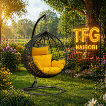 A premium SERENGETI BY188 swing chair with vibrant yellow cushions, displayed in a lush garden setting at a villa near Crystal Mall, Athi River.