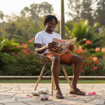 Black male reading magazine on EO197B Eames Chair black Nairobi – comfortable seating