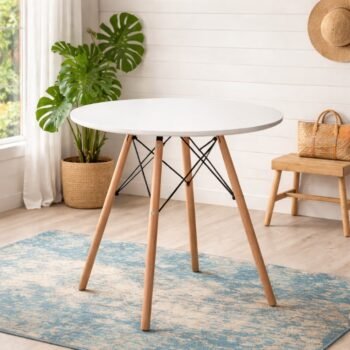 EO1607 white Eames round table with beech wood legs in a minimalist Hurlingham studio apartment.