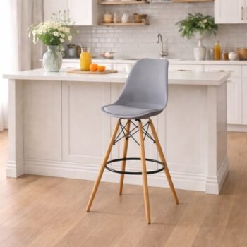 Gray EO1801 Eames bar chair with padded PU leather seat and chrome braces in a modern Lavington kitchen.