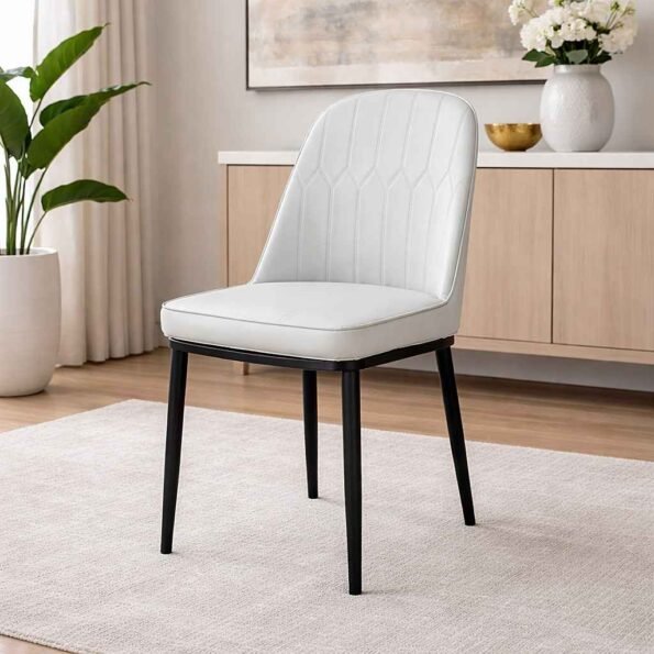 JNRD11-1 white PU leather dining chair with curved back and diamond quilting in a modern Kilimani, Nairobi apartment.