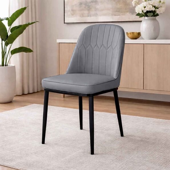 JNRD11-2 gray faux leather dining chair with channel tufting and metal legs in a Hurlingham, Nairobi studio apartment.