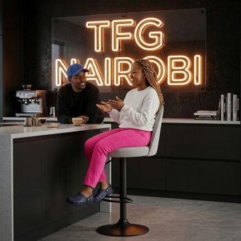 Lady sitting on a JH177-4 Andreu World bar stool with backrest at a modern kitchen counter in Kilimani Nairobi.