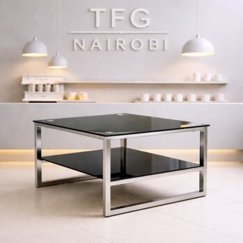 Hapina Gallery LUXC1800-1 black glass coffee table with a polished chrome square frame and lower storage shelf in a modern Gigiri lounge.