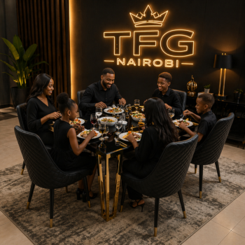 A happy family of six sharing a meal on a LUX1877 black glass dining table with gold legs and quilted leather chairs in a luxury Westlands home.