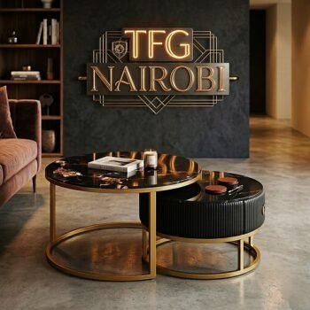 Exclusive Poltrona Frau J405 nesting table set with gold frames, a glass top, and a grey leather storage drawer in a luxury Kileleshwa living room.