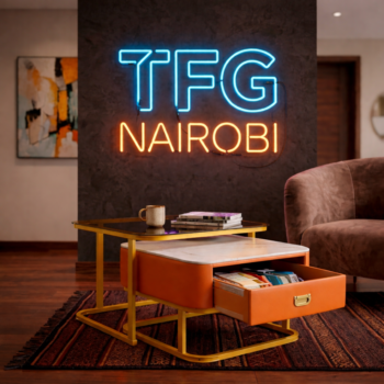 Luxury PF-LUX1200 nesting coffee table set in a Kilimani living room with the orange leather storage drawer open to show organized interior.