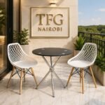 ECBT3-1 Balcony Set by Eames & Vitra Nairobi – 2-seater outdoor bistro set with round black glass-top table, chrome legs and white lattice-back chairs with wooden legs, styled on a luxury marble balcony in Karen, Nairobi, Kenya