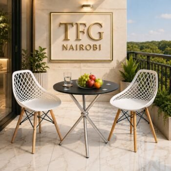 ECBT3-1 Balcony Set by Eames & Vitra Nairobi – 2-seater outdoor bistro set with round black glass-top table styled with fruit bowl and water glass, flanked by two white lattice-back chairs with wooden legs on a luxury marble balcony in Karen, Nairobi, Kenya