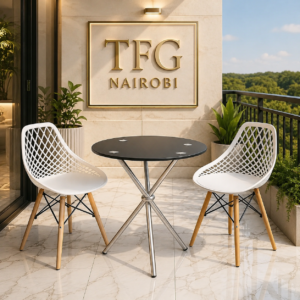 The ECBT3-1 balcony set kenya – by Eames & Vitra Nairobi featuring a round black glass-top table with chrome tripod legs and two white lattice-back chairs with wooden legs on a luxury marble balcony overlooking Nairobi