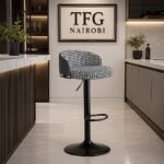 Houndstooth Adjustable Bar Stool with Back – Black & White with a curved upholstered backrest and black accent trim, staged at a luxury kitchen island in Karen, Nairobi.
