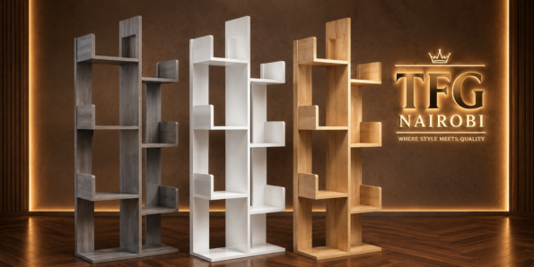 Small Space, Big Style: Why Tree Bookshelves Are the Ultimate Urban Storage Trend in Nairobi. Three unstyled TFG Nairobi 8-tier tree bookshelves in grey wood-grain, glossy white, and natural oak finishes standing in a row on a hardwood floor under a gold glowing TFG NAIROBI banner sign that reads "WHERE STYLE MEETS QUALITY."