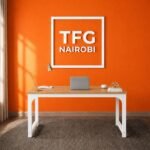 TFG VM1.6M Oak White computer table workstation installed in a Kitisuru home office in Nairobi, featuring a 1.6m wide oak top and white arch-braced legs.
