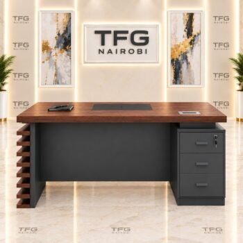 Seated working view of 1.4m Executive Office Desk featuring attached 3-drawer lockable pedestal with key, central writing pad inlay, and cable grommet in Upper Hill, Nairobi